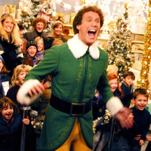 Buddy the Elf coat featuring a bright green design with white fur trim, gold buttons, and festive holiday style.