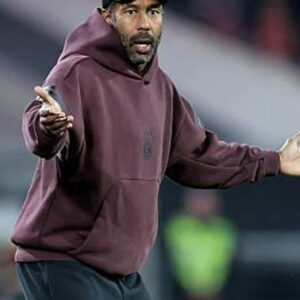 Fortuna Düsseldorf coach Daniel Thioune burgundy hoodie with casual fit and team-inspired design.