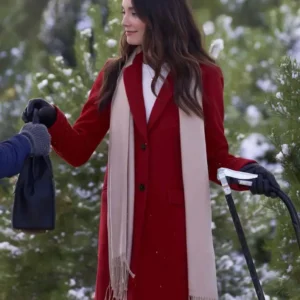 Mallory Jansen wearing a stylish coat in On The 12th Date of Christmas, featuring a long tailored design with a classic collar and winter-ready fabric.