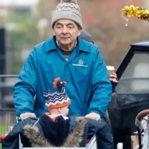 “Rowan Atkinson Man VS Baby 2025 blue jacket displayed on a hanger.”