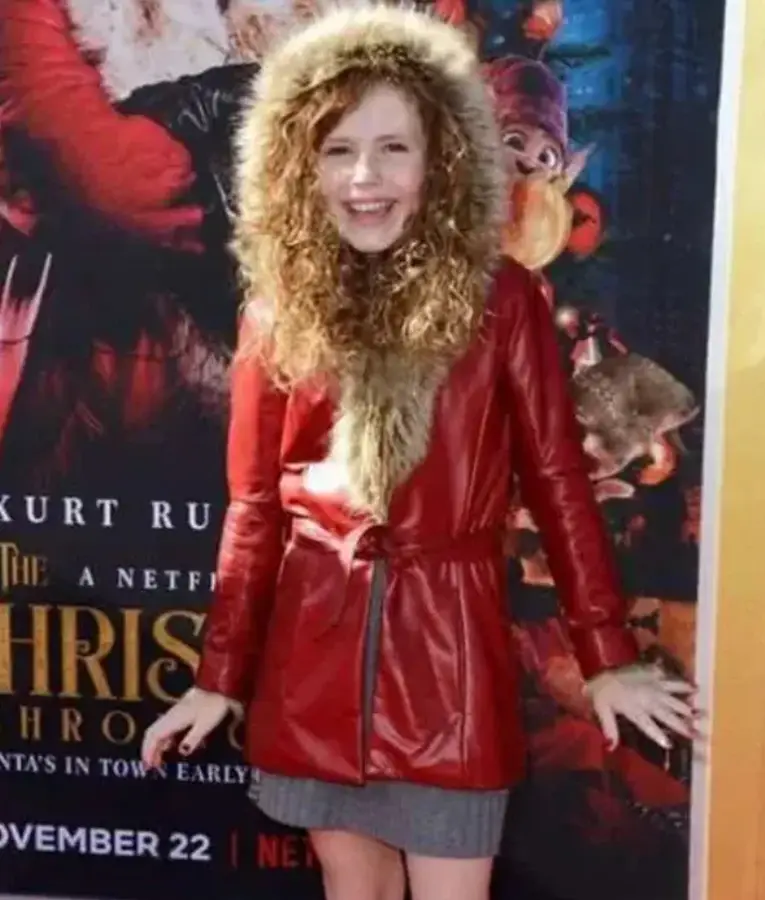 Darby Camp wearing a long premiere coat in The Christmas Chronicles 2, featuring a warm wool-like fabric, button closure, and elegant winter design.