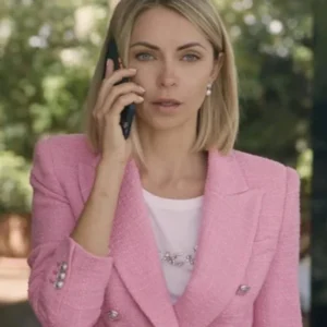 Irma Lake wearing a pink tweed blazer in The Lost Princess, featuring a tailored fit, button closure, and textured woven fabric.