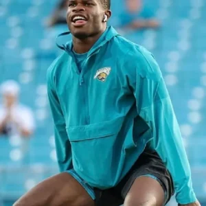 “Travis Hunter Jaguars Sideline Anorak Jacket with team branding displayed on a hanger.”